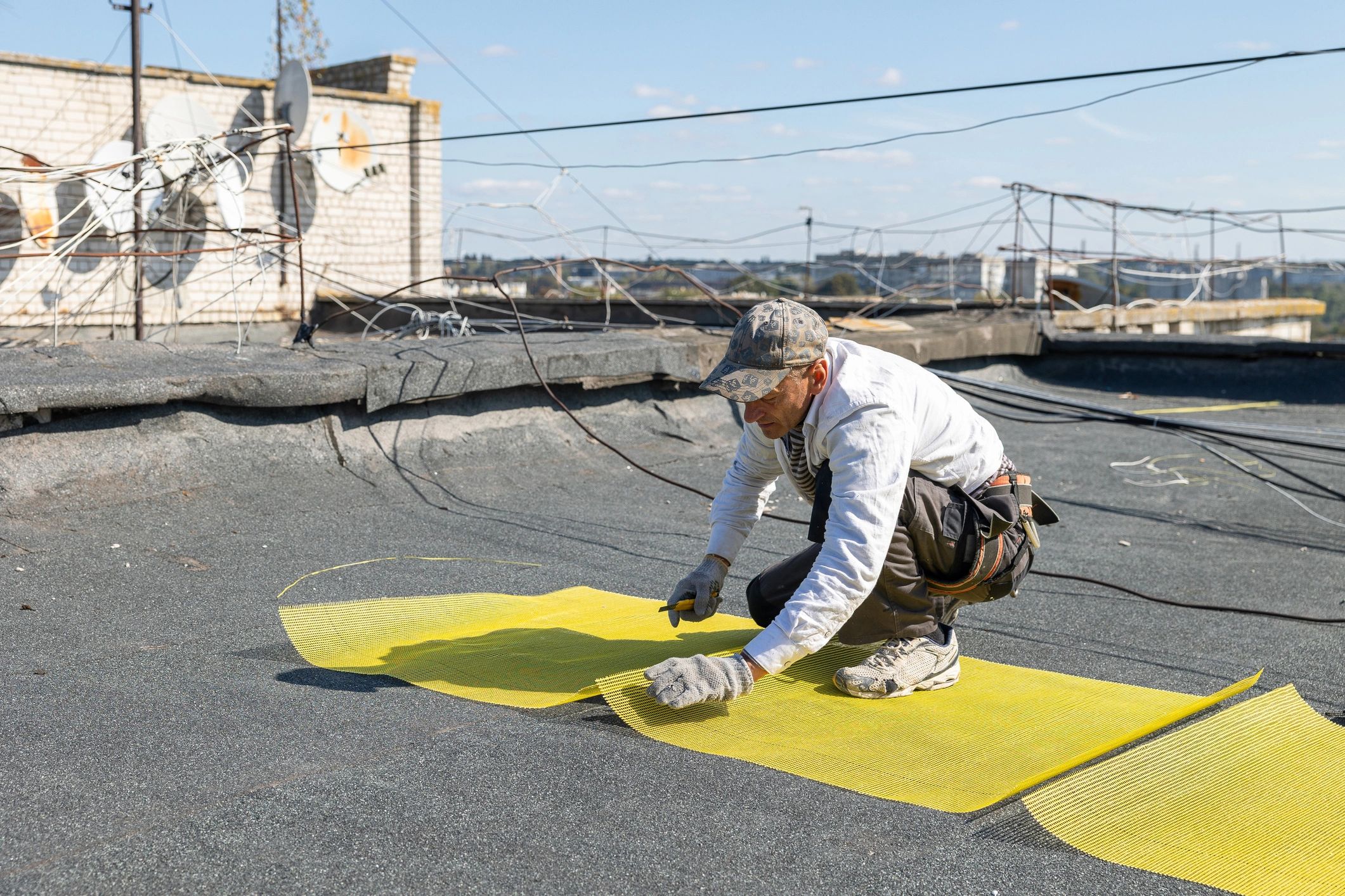 Technician carrying out elevated access work on a roof