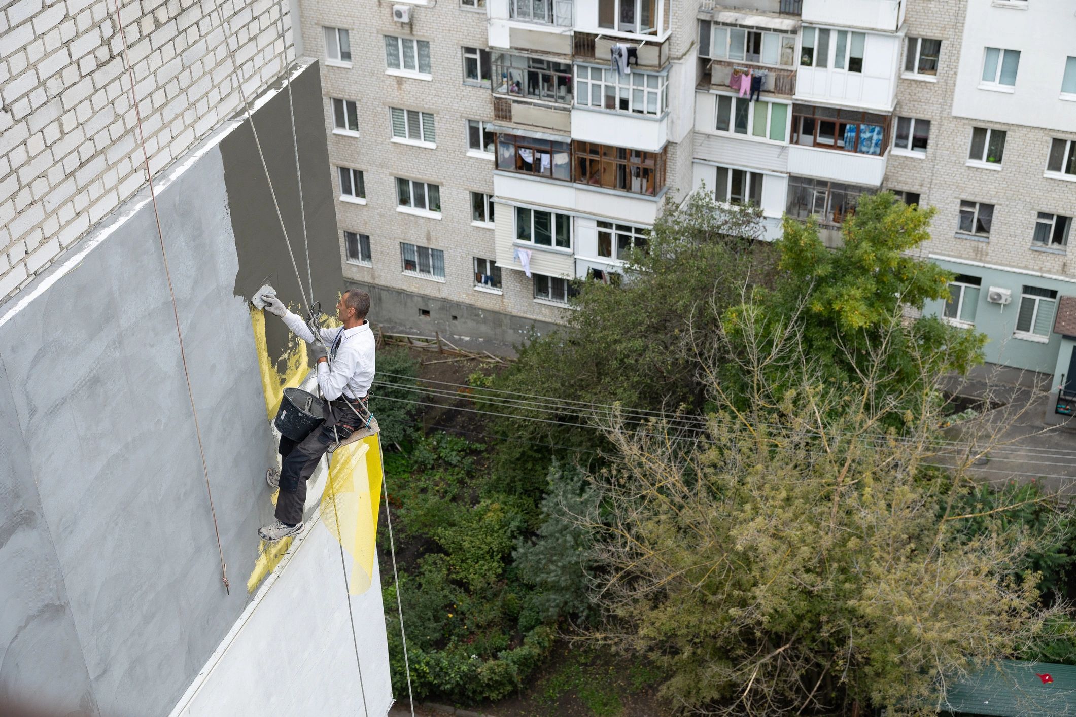 Rope access worker carrying out facade work at height