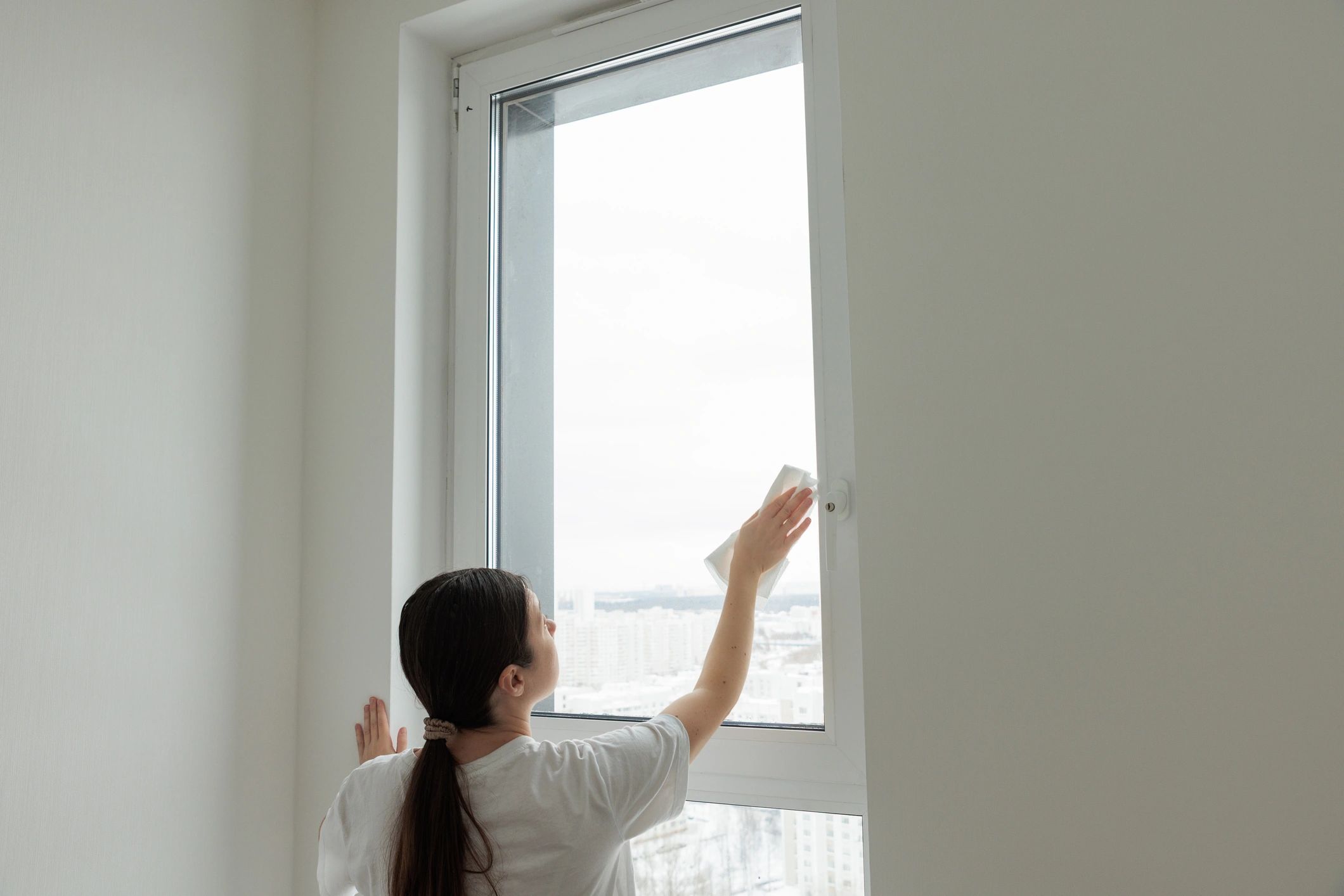 Worker cleaning a tall window